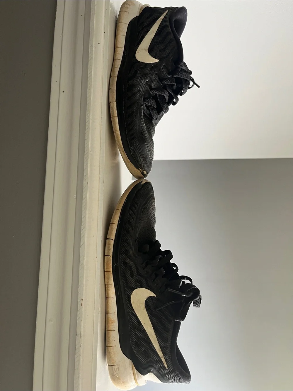 Nike Black Trainers with White Swoosh Accent